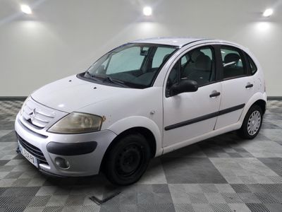 a picture of a small white car parked in a garage