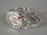 a close up of a silver wrist watch on a table