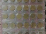 a lot of coins in a plastic container on a table