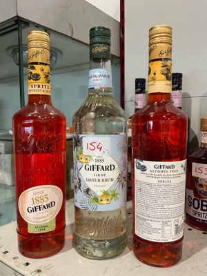 several bottles of alcohol are lined up on a counter