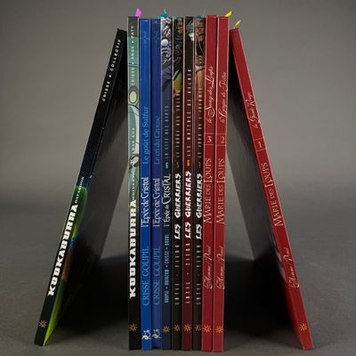 books are stacked on top of each other on a gray surface