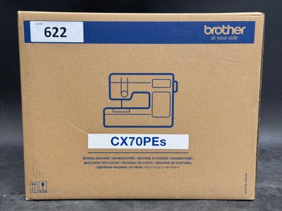 a box of brother cx70pes sewing machine sitting on a table