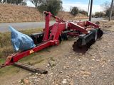 a red tractor that is sitting on the side of the road