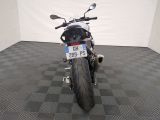 a motorcycle that is parked in a room with a checkered floor