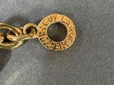 a gold chain with a coin attached to it