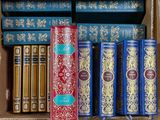 many books that are in a box on the shelf