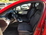 the interior of a red car with black seats and a steering wheel