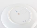 a white plate with a picture on it on a table