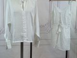 two dresses on display on a stand in a room