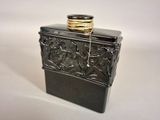 a small black box with a gold ring on top of it