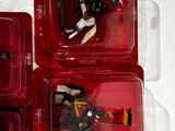 four plastic boxes with toy figures in them on a white surface