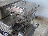 several trays of food sitting on top of a counter in a kitchen