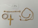 a close up of a cross, a ring, and a chain
