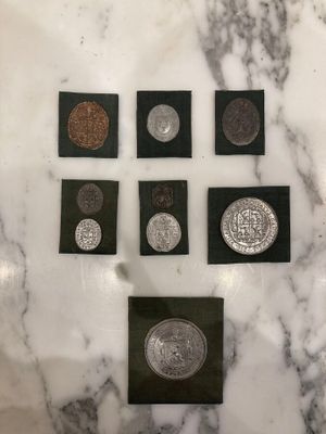 a marble table topped with a bunch of different types of coins