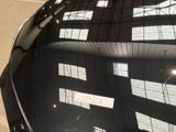 a reflection of a building on the windshield of a car