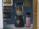 packaging of a blender sitting on top of a table next to a blender