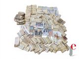 a pile of old money sitting on top of a table