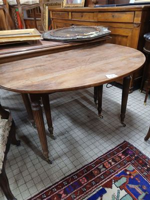 a table and chairs in a room with a rug on the floor