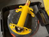 a yellow tool sitting in a black case on a table