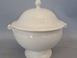 a large white bowl with a lid on a table