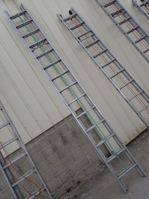many ladders that are leaning against the wall