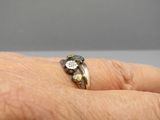 a close up of a person ' s hand with a ring on it