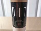 a picture of a bottle of dit cosmetics sitting on a table