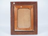an old wooden picture frame with a piece of linen on it
