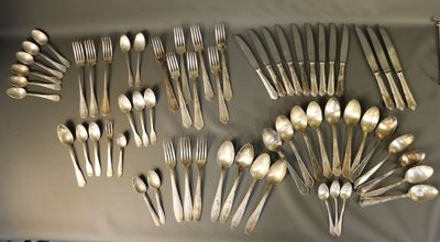 a lot of silver spoons and forks on a table