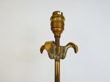 an antique brass table lamp with a glass shade on top of it