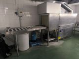 a machine that is sitting in a kitchen with a trash can
