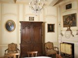 an image of a bedroom with a bed and a cabinet