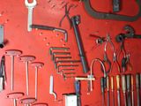 many tools hanging on the wall in the garage
