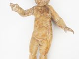 a wooden doll that is laying down on the floor