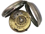 a close up of a pocket watch on a white background