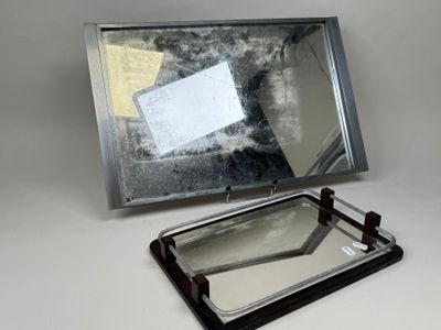 un miroir posé sur une table à côté d'une feuille de papier