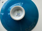 a blue plate with a small white bowl on it