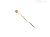 a close up of a gold stick with a flower on it