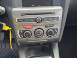 a car dashboard with a steering wheel and a control panel