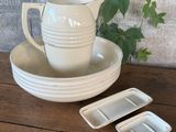 a white cup and saucer sitting on a wooden table