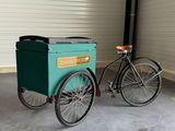 a bike with a cart attached to it in a garage