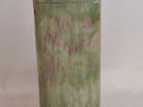 a small green vase with a cat head on it