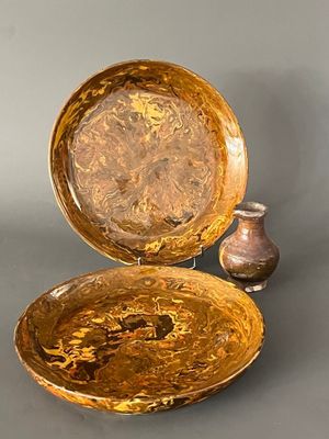 two bowls and a vase sitting on a table