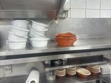 many plates and bowls on the counter in the kitchen