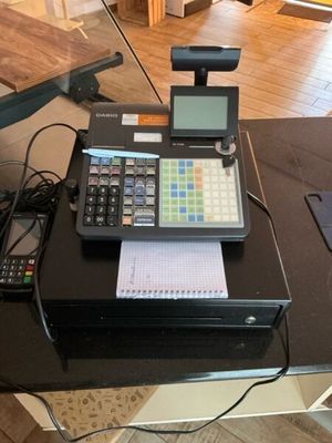 a cash register and a calculator sitting on a table