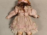 an image of a doll is laying on a white surface
