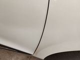 a close up of a white car with a flat tire