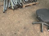 a pile of pipes and a chair on the floor