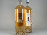 two bottles of wine sitting next to each other on a table