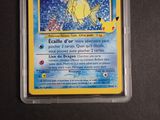 a pokemon card in a plastic container on a table